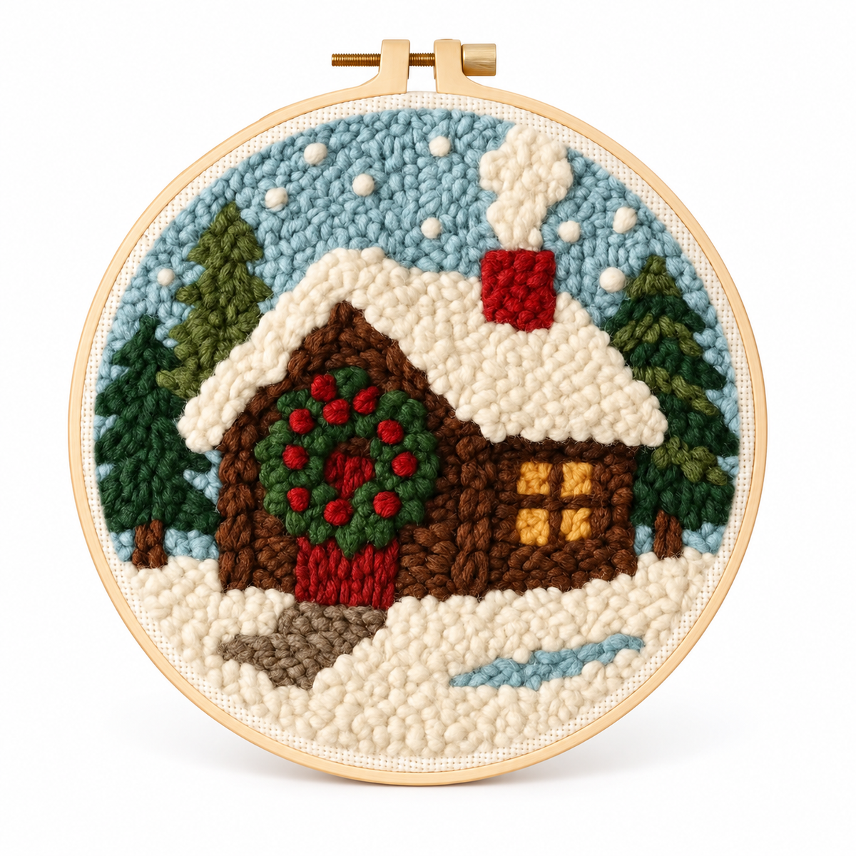 Winterhausmotiv mit verschneitem Holzhäuschen, grünem Türkranz und Tannen vor blauem Himmel im runden Rahmen.